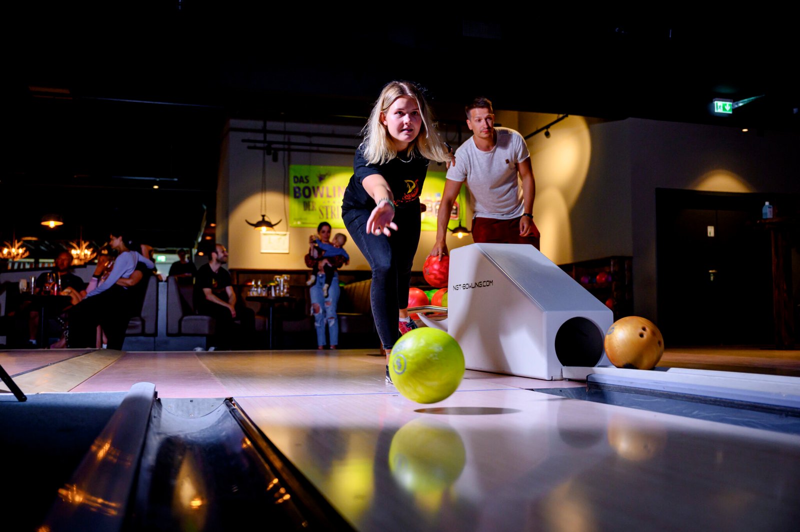 Eine Frau beim Bowling im Ostsee Resort Damp, einem Urlaubsziel.